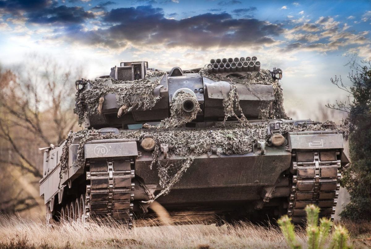 Leopard 2 tank with camouflage netting on a heath