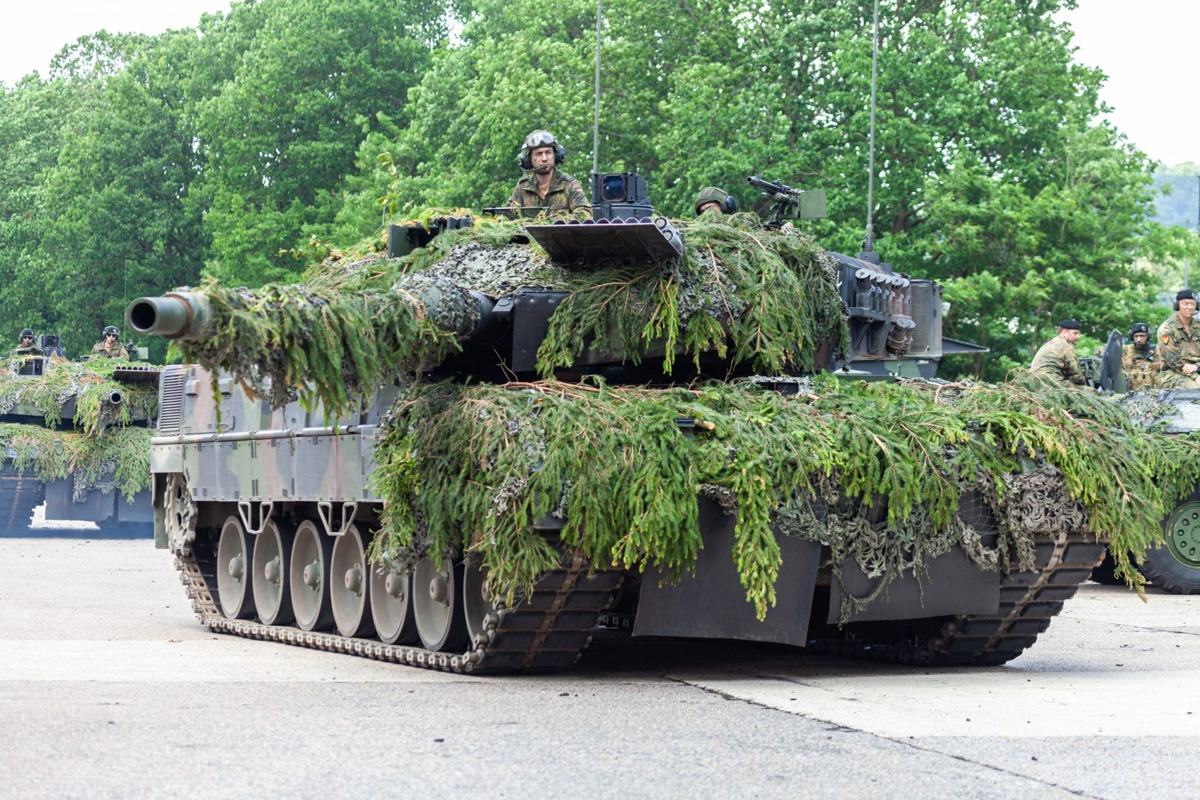Leopard 2A6 covered in camouflage foliage